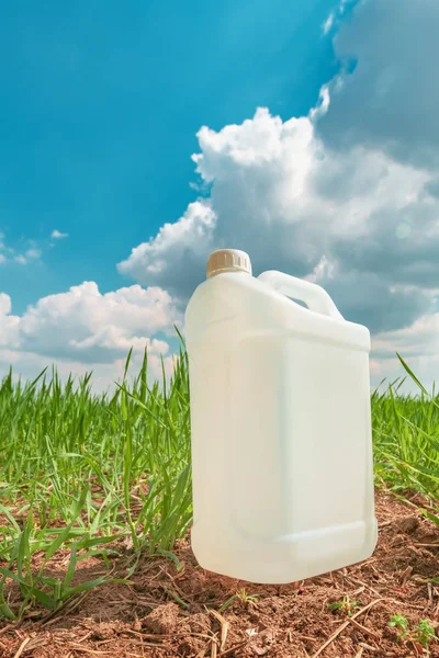 Blank bekämpningsmedel behållaren mock upp i vetegräs fältet — Stockfoto