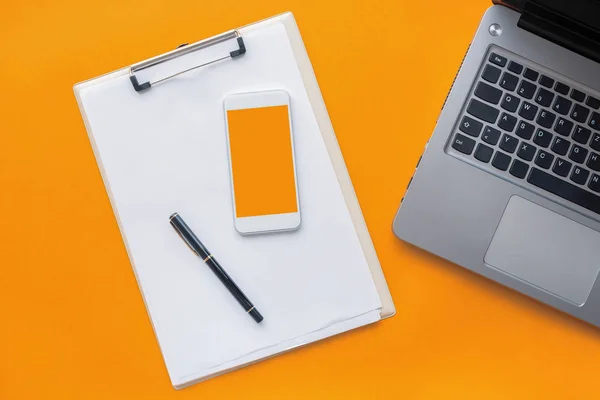 Clipboard notepad, smartphone and laptop computer — Stock Photo, Image