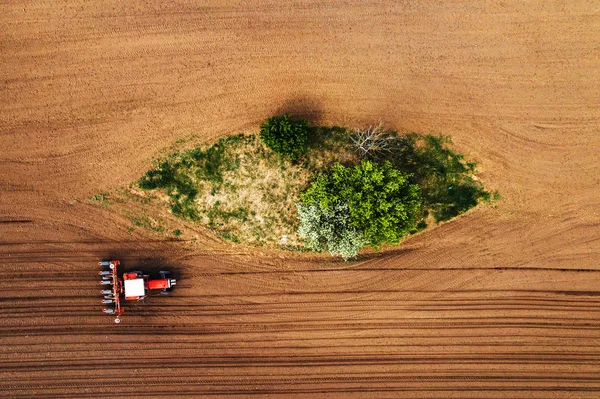 Top view of tractor with seeder from drone pov — Stock Photo, Image