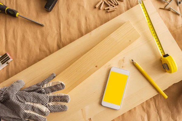 Modern smartphone with blank screen mock up in carpentry worksho — Stock Photo, Image