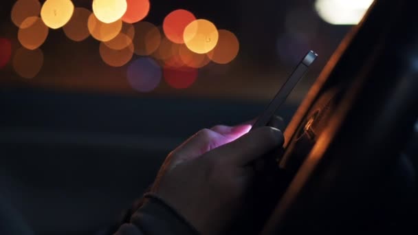 車の中で夜に車の中で携帯電話で女性のテキストメッセージ 通信のためのスマートフォンを使用して大人の女性 低キー選択的フォーカス — ストック動画