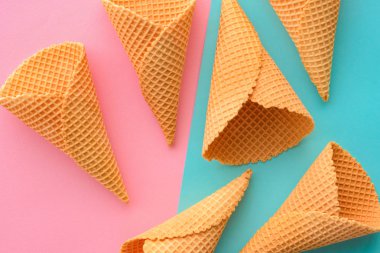 Pastel pembe ve mavi arka plan üzerinde dondurma waffle konileri