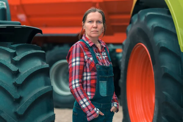 Female farmer and agricultural tractor — Stock Photo, Image