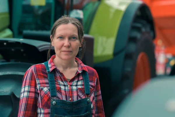 Female farmer and agricultural tractor — Stock Photo, Image