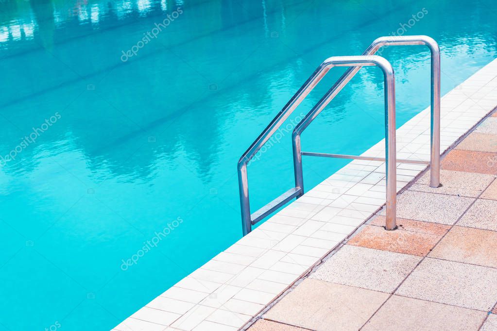 Outdoor swimming pool water and aluminum ladder