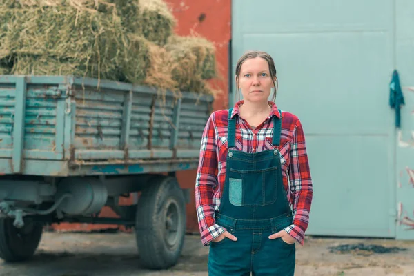 Agricultrice posant devant un chariot à foin — Photo