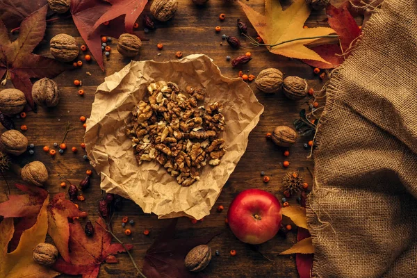 Leckere rote Äpfel und Walnussfrüchte von oben — Stockfoto