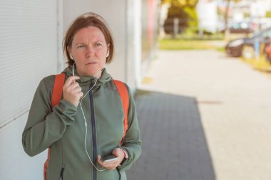 Female jogger talking on mobile phone handsfree clipart