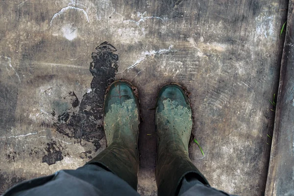 Top view of farmer wearing dirty rubber boots — Stock Photo, Image