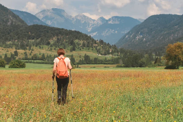 Caminhante feminina está caminhando na paisagem rural alpina em autu — Fotografia de Stock