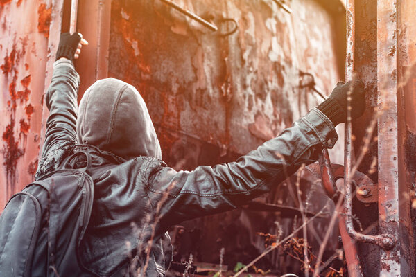 Homeless immigrant climbing on freight train, conceptual image with selective focus