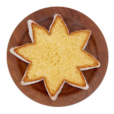 Star shape slice of pandoro, Italian sweet yeast bread, traditional Christmas treat. Overhead flat lay view. Isolated on white. clipart