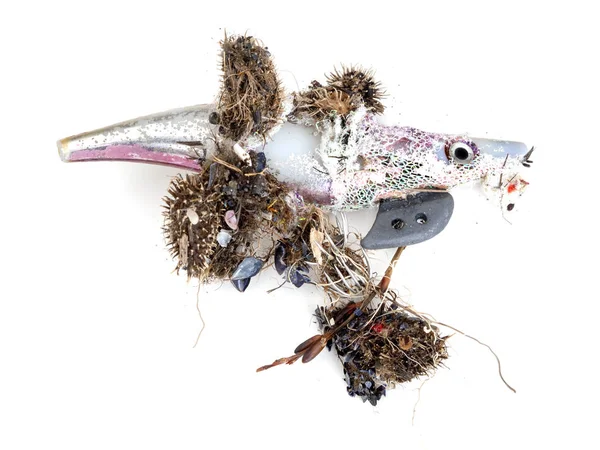 Señuelo de pesca de plástico lavado en la playa, la contaminación del medio ambiente, sino también el peligro - con ganchos feroces. Fondo blanco . — Foto de Stock