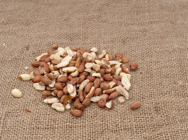 Wild bird food - unsalted peanuts, on hessian. Help feed garden birds wildlife in winter. — Stock Photo, Image