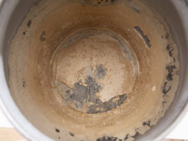 Limescale, scale in old kettle. A white, chalky residue from deposit of calcium carbonate. Hard water problem. clipart