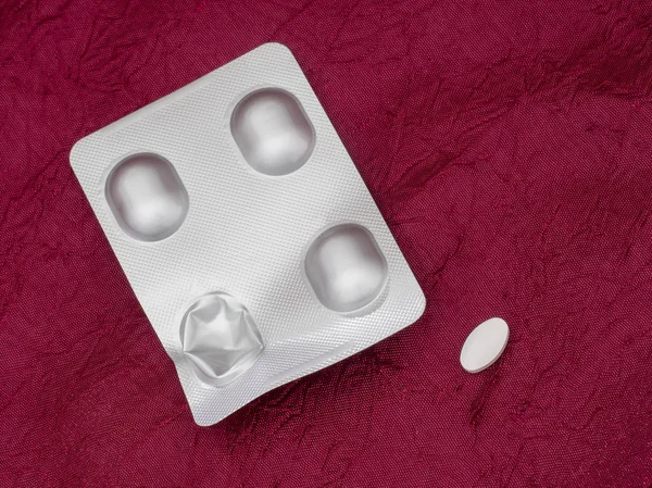 Alendronate sodium pack, nonhormonal medication for treating postmenopausal osteoporosis in women. On red cloth. — Stock Photo, Image
