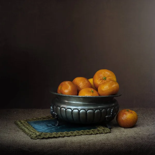 Chiaroscuro style still life with oranges in pewter bowl. Retro. — Stock Photo, Image