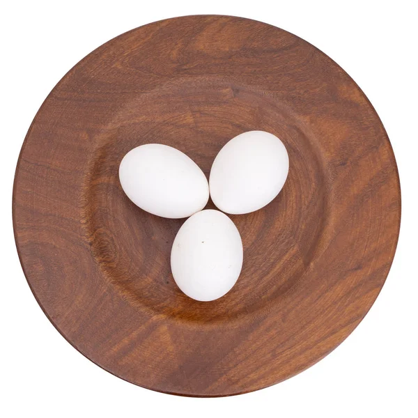 Three white chicken, hens eggs on wooden plate isolated on white. — Stock Photo, Image