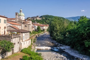 Tuscan village of Pontremoli with the Magra river in the forefront and iconic buildings in the background. clipart