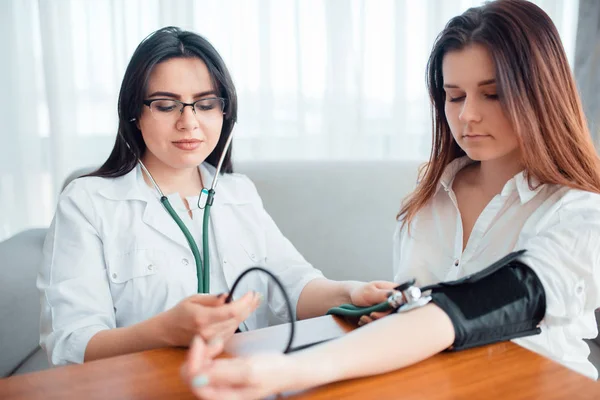 Doctor Examining Female Patient Professional Healthcare Measuring Blood Pressure Young — Stock Photo, Image