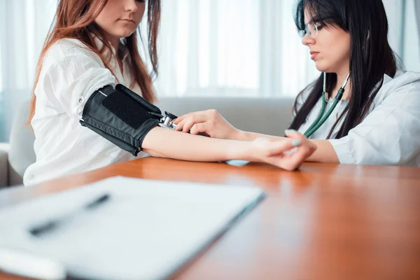 Doctor Examining Female Patient Professional Healthcare Measuring Blood Pressure Young — Stock Photo, Image