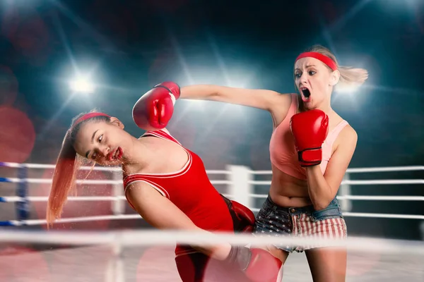 two female kickboxers fighting on the ring