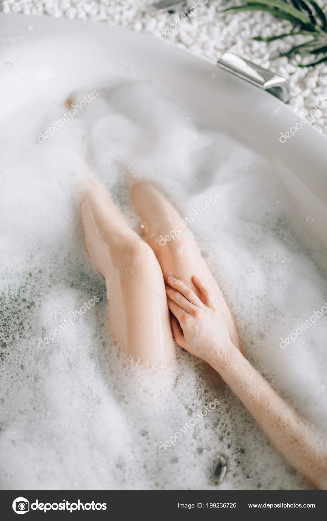 Attractive lady lying in bath with rose petals Stock Photo by NomadSoul1