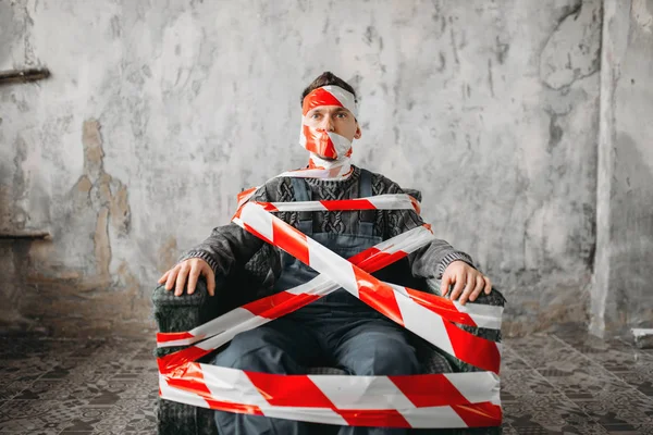 Homem Envolto Fita Cola Sentado Numa Poltrona Sala Grunge Mad — Fotografia de Stock