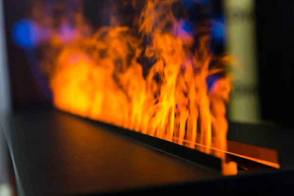 Flame line from gas fireplace, closeup. Fire, romantic interior decoration