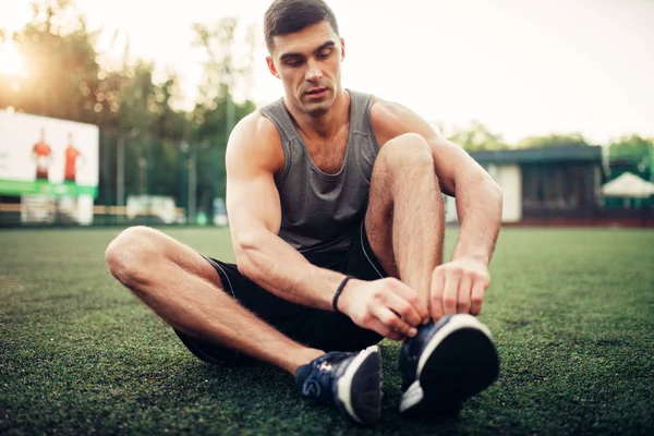 Man Prepares Outdoor Fitness Workout Sportsman Sitting Grass Tying Shoelaces — Stock Photo, Image