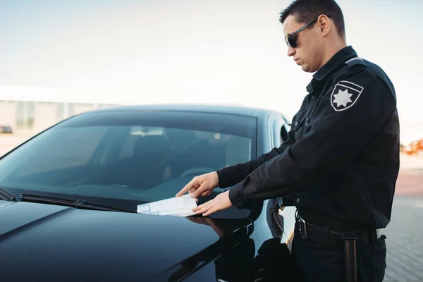 穿制服的男警察在路上写了一条罚款 法律保护 汽车交通检查员 安全控制工作 — 图库照片
