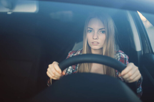 Female student on driving exam, car school concept. Test for drivers, automobile course for beginners