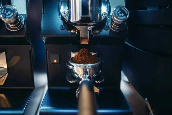 Coffee machine with fresh ground grains closeup, nobody. Professional espresso preparation, restaurant, cafe or cafeteria business tools