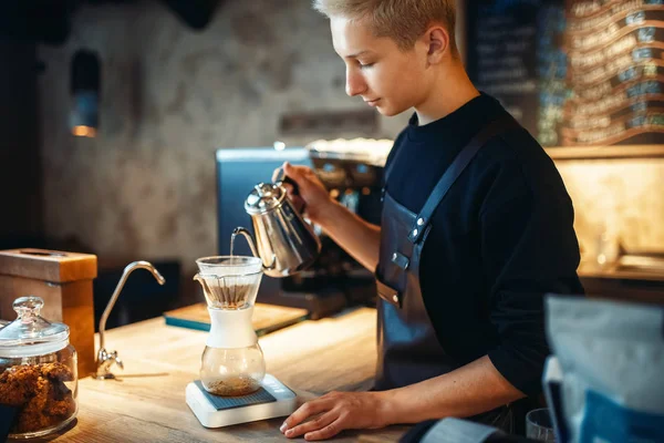 Male Barista Pours Ground Coffee Glass Standing Stove Barman Works — Stock Photo, Image