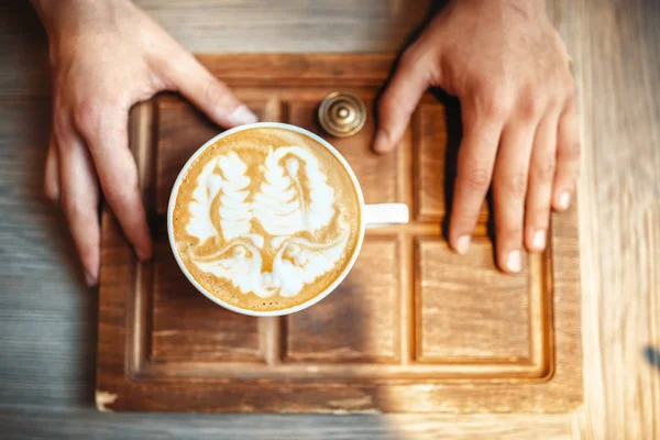 Male Barista Holds Cup Coffee Foam Drawing Top View Wooden — Stock Photo, Image