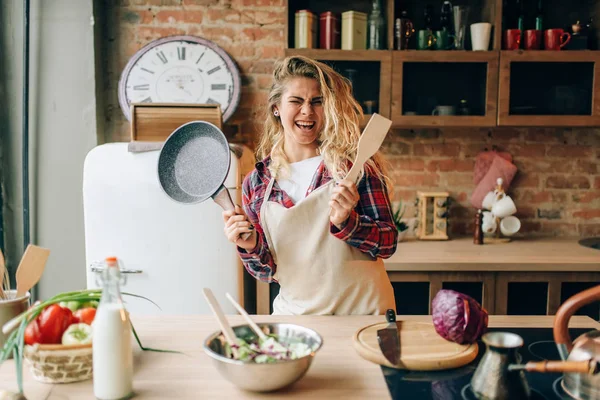 Smiling Housewife Apron Holding Frying Pan Wooden Spatula Hands Kitchen — Stock Photo, Image