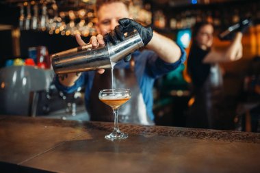Erkek barmen shaker barda içki dökülen sayaç. Alkollü kokteyl hazırlama. Barmen meslek, barmenlik