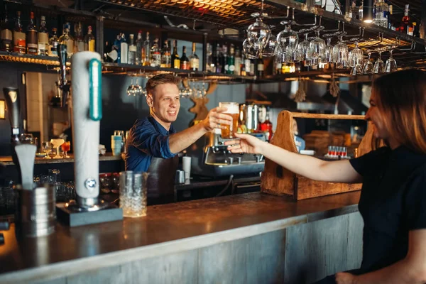 Male Barman Passes Glass Beer Female Visitor Barkeeper Occupation Bartender — Stock Photo, Image