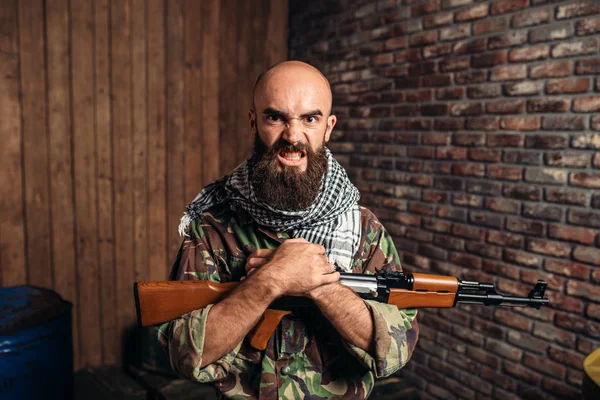 depositphotos_214488624-stock-photo-terrorist-in-uniform-holds-kalashnikov.jpg