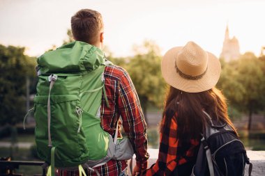 Yürüyüşçüler sırt çantaları ile dağın tepesinden cityscape üzerinde görünüyor. Hiking yaz. Macera genç çiftin zammı