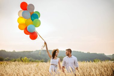 Çift renkli hava balonları bir çavdar alanda ile seviyorum. Yaz çayır üzerinde güzel kadın
