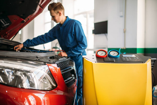 Mechanic checks air conditioning system in car. Conditioner inspection, diagnostic