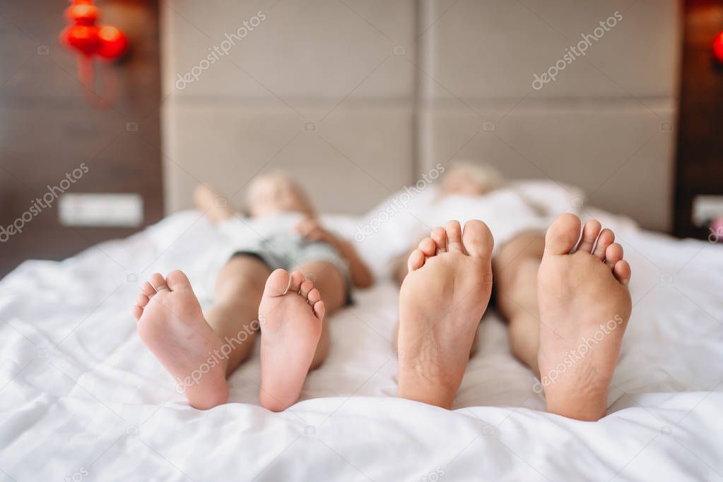 Mother and child leisure and lying on the bed at home. Parent feeling, togetherness