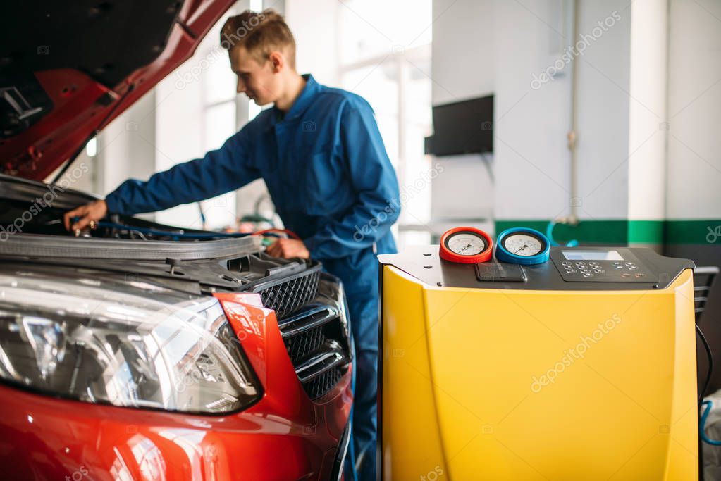 Mechanic checks air conditioning system in car. Conditioner inspection, diagnostic