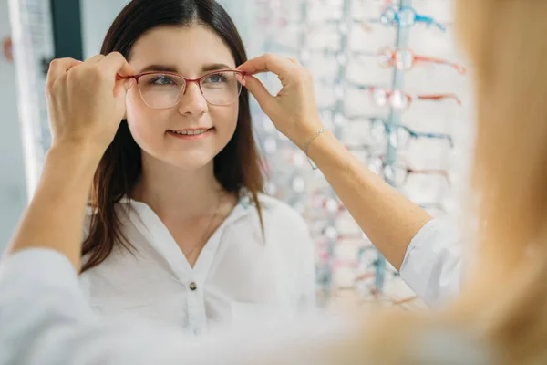 Female Optician Customer Chooses Glasses Frame Showcase Eyeglasses Optics Store — Stock Photo, Image