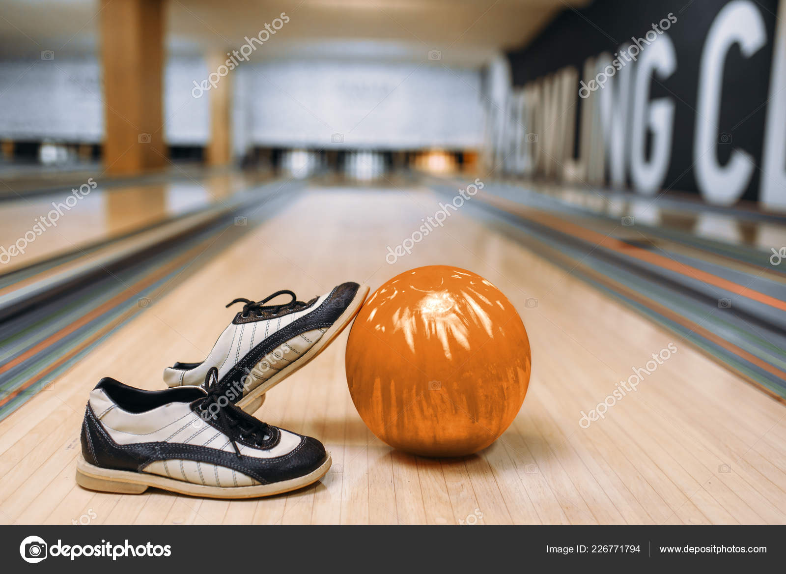 Bowling ball and house shoes on lane in club Stock Photo by NomadSoul1