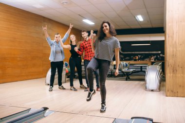 Kadın Melon lane, strike atış topu atar. Oyun Kulübü, etkin boş oynayan bowling salonu takımlar