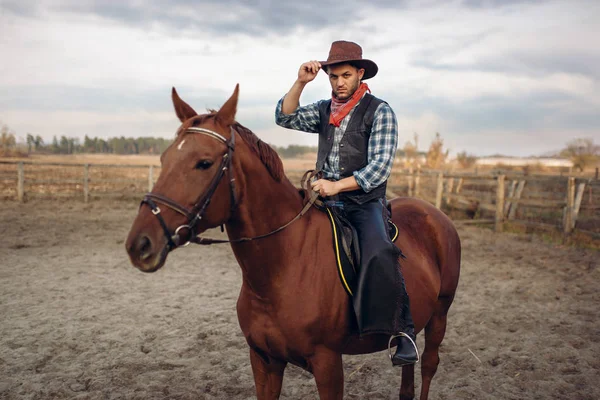 Cowboy riding a horse on a ranch, western. Vintage male person on horseback, wild west adventure