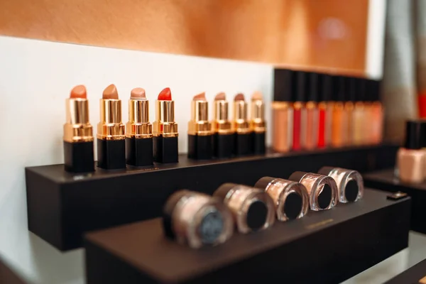 Lipstick collection, showcase in beauty shop closeup, nobody. Makeup products in store, cosmetic department