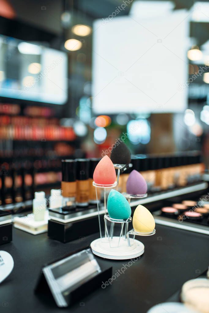 Make-up cosmetic collection in beauty shop closeup, nobody. Makeup products on showcase in store